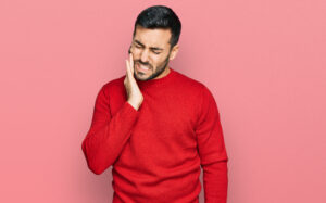 Young Hispanic Man Wearing Casual Clothes Touching Mouth With Hand With Painful Expression Because Toothache Dental Illness Teeth Dentist 300x187